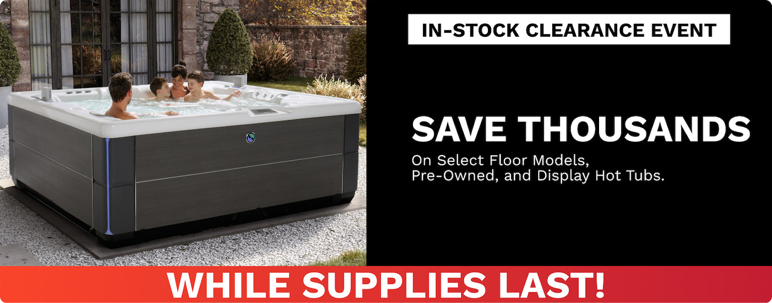 Four people in an outdoor modern hot tub; ad banner reads In-Stock Clearance Event—Save Thousands; While Supplies Last.